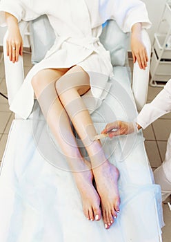 Application of contact gel before laser hair removal procedure