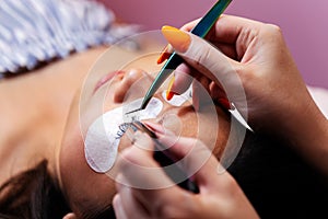 application of false eyelashes with tweezers