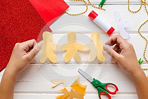 Application for kids. Christmas or New year card with gingerbread man from paper. DIY.