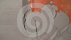 Plastering a brick wall, applying a layer of cement mortar