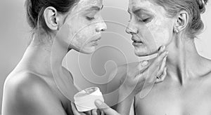 Applying clay mask. Spa and wellness. Girls friends sisters making clay facial mask. Anti age care. Stay beautiful. Skin