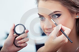 Applying eyeshadow