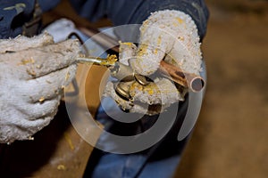 Applying flux on brass fitting for copper solder joint water pipes