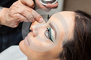 Applying foundation using a sponge to a white woma