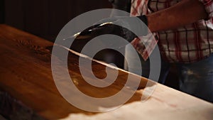 Applying fresh varnish on a wooden table