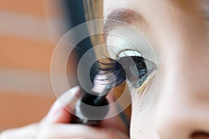 Applying liquid eyeliner with brush, close up