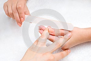 Applying manicure with nail-file