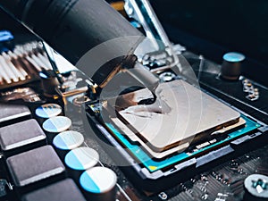 Applying new thermal paste to a CPU. Thermal paste used as an interface between heat sinks and CPU.