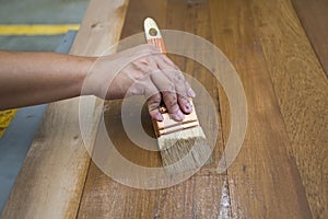 Applying protective varnish on a wooden furniture