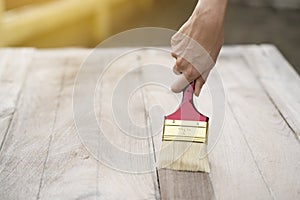 Applying protective varnish on a wooden texture