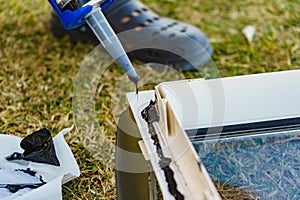 Applying silicon on caravan sunroof