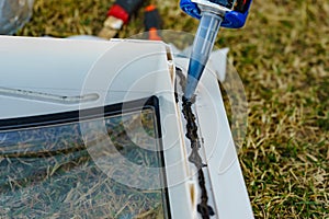 Applying silicon on caravan sunroof photo