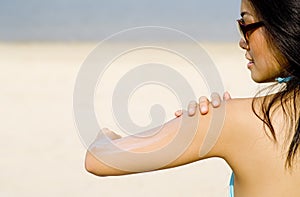 Applying Suncream At Beach