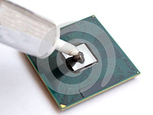 Applying thermal grease paste on a computer cpu processor