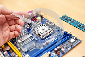 Applying thermal paste to a computer processor. Processor installation concept and cooling solution