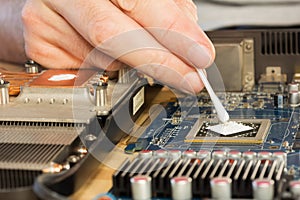 Applying thermal paste to the video processor. close-up