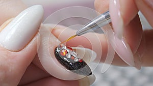 Applying a three-dimensional pattern with rhinestones and broths on the nail.