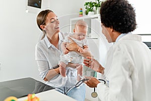 Appointment with a consultant pediatrician. Mother and baby at pediatrician`s office.