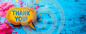 Appreciation message THANK YOU! in bold letters on a speech bubble cutout, placed on a vibrant blue background, symbolizing