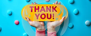 Appreciation message THANK YOU! in bold letters on a speech bubble cutout, placed on a vibrant blue background, symbolizing