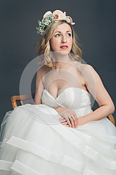 Apprehensive young bride sitting thinking