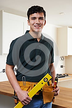 Apprentice Carpenter Installing Luxury Fitted Kitchen