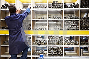 Apprentice Checking Stock Levels In Store Room