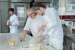 Apprentice chef preparing food in kitchen at restaurant