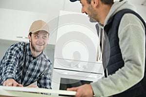 apprentice and cratsman working in kitchen