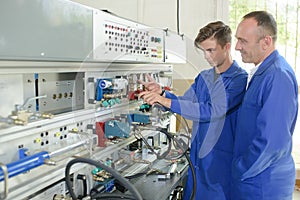 Apprentice electrician and tutor photo