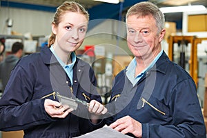 Apprentice Engineer Measuring Component With Micrometer