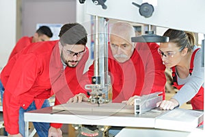 apprentice and engineer using computer controlled cutting machine