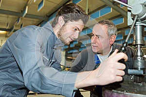 Apprentice engineer working on factory floor