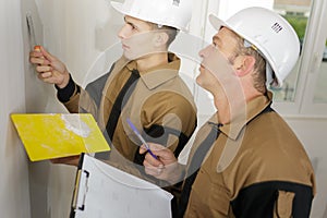 apprentice filling wall