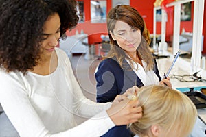 apprentice hairdresser doing hairdo