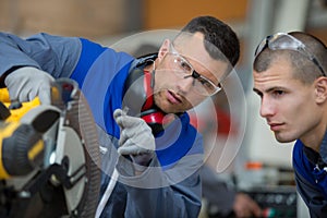 apprentice learning how to use circular saw
