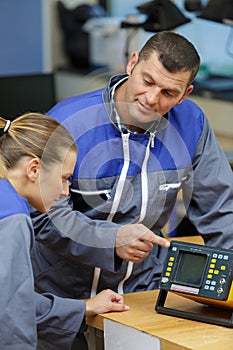 apprentice learning how to use electrical equipment