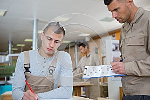 Apprentice learning to draw in workshop photo