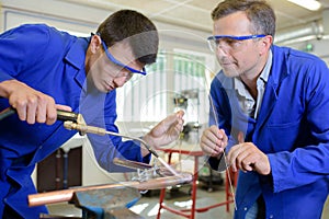 Apprentice learning to use blow torch