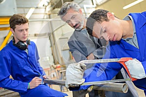 Apprentice learning to use bow saw