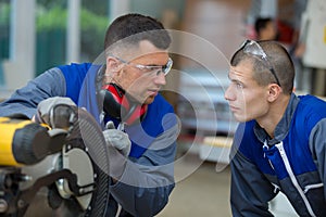 apprentice learning to use circular saw