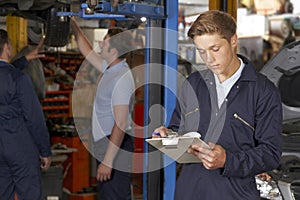 Apprentice Mechanic Working In Auto Repair Shop