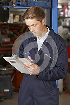 Apprentice Mechanic Working In Auto Repair Shop