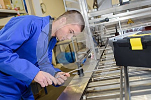 Apprentice mechanic working at factory