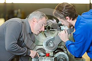 Apprentice mending lathe machine
