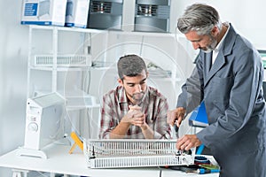 Apprentice repairing appliance with mentor