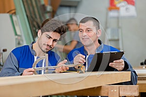 apprentice or trainee beeing tested by craftsman