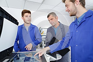 Apprentices around the printer