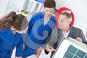 Apprentices learning to clean filter