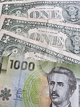 approach to Chilean banknote of 1000 pesos and American one dollar bills